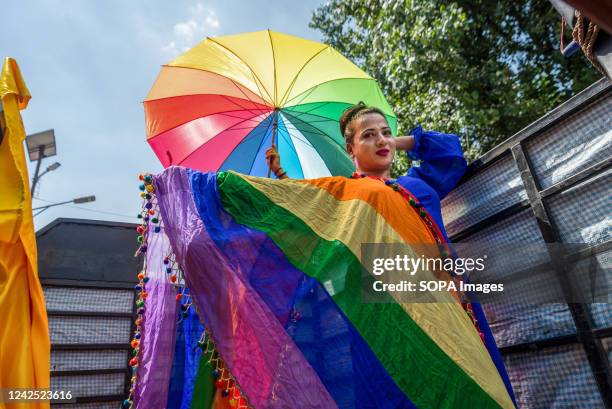 Nepalese reveler poses with a rainbow umbrella and shawl during the pride parade of LGBTQIA . People from LGBTQIA gathered and attended the parade to...