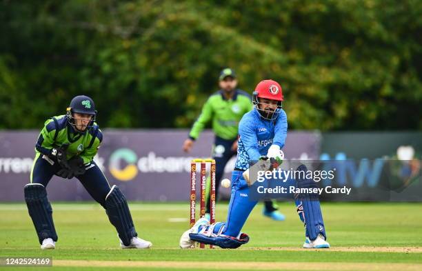 Belfast , United Kingdom - 15 August 2022; Rashid Khan of Afghanistan and Ireland wicketkeeper Lorcan Tucker during the Men's T20 International match...