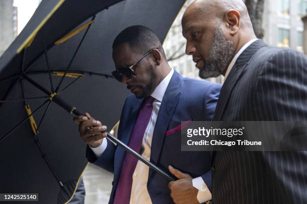 Amp;B superstar R. Kelly arrives at the Daley Center to attend a closed-door hearing in a court fight with his ex-wife over child support on March 13...