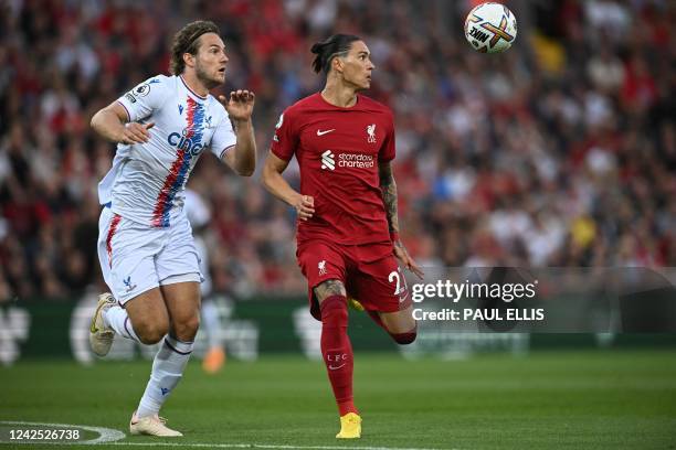 Crystal Palace's Danish defender Joachim Andersen and Liverpool's Uruguayan striker Darwin Nunez eye the ball during the English Premier League...