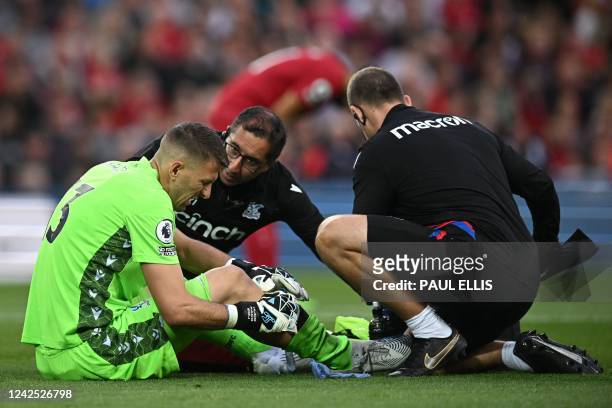 Crystal Palace's Spanish goalkeeper Vicente Guaita recives medical attention after an injury during the English Premier League football match between...