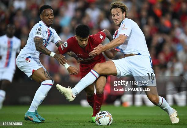 Liverpool's Colombian midfielder Luis Diaz fights for the ball with Crystal Palace's English defender Nathaniel Clyne and Crystal Palace's Danish...
