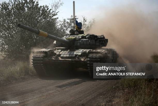 Ukrainian tank rolls down a road at a position along the front line in the Donetsk region on August 15 amid Russia's invasion of Ukraine.