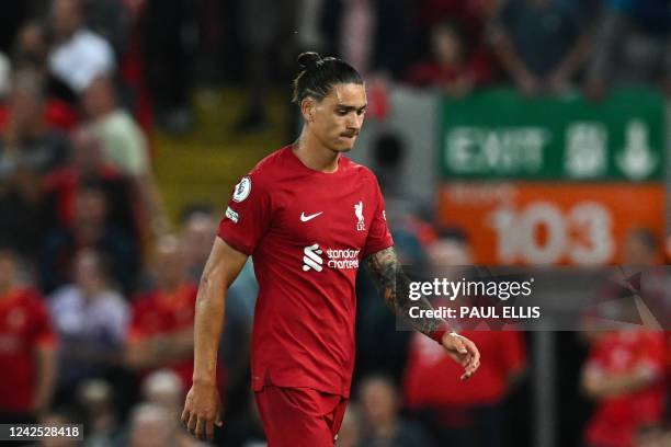 Liverpool's Uruguayan striker Darwin Nunez reacts as he leaves the pitch after being sent off by the referee during the English Premier League...