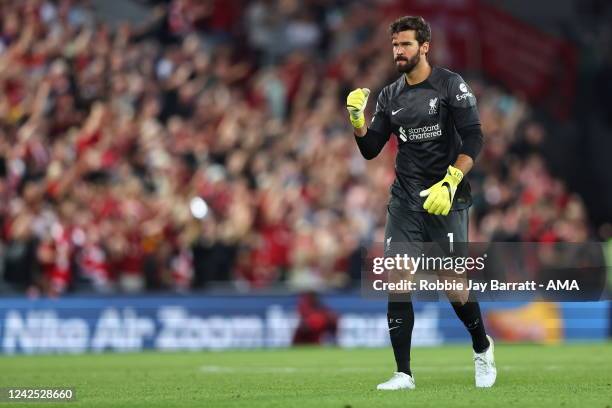 Alisson Becker of Liverpool celebrates after Luis Diaz of Liverpool scores a goal to make it 1-1 during the Premier League match between Liverpool FC...