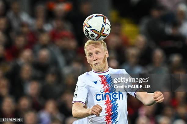 Crystal Palace's English midfielder Will Hughes heads the ball during the English Premier League football match between Liverpool and Crystal Palace...