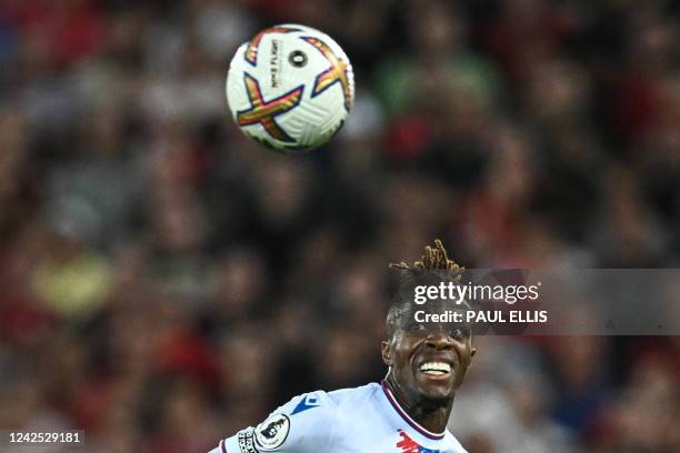Crystal Palace's Ivorian striker Wilfried Zaha eyes the ball during the English Premier League football match between Liverpool and Crystal Palace at...