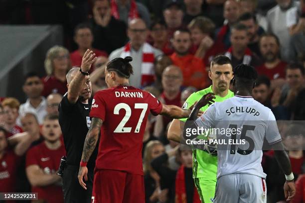 Liverpool's Uruguayan striker Darwin Nunez is sent off from the pitch by referee Paul Tierney after committing a foul during the English Premier...