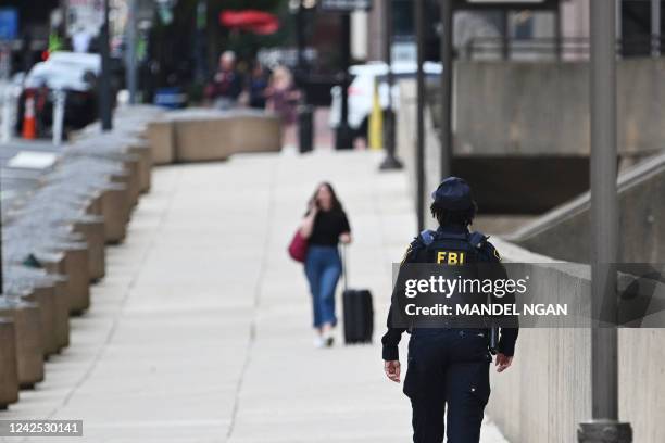 Security personnel patrol around the headquarters of the Federal Bureau of Investigation in Washington, DC on August 15, 2022. - Threats against the...