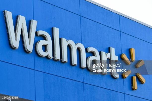 The Walmart logo is seen outside a Walmart store in Burbank, California on August 15, 2022. - Walmart, the largest retailer the United States, will...