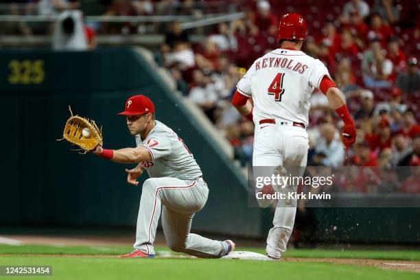 Rhys Hoskins of the Philadelphia Phillies catches the ball at first base to force out Matt Reynolds of the Cincinnati Reds in the ninth inning at...