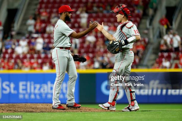 Pitcher Seranthony Dominguez of the Philadelphia Phillies is congratulated by J.T. Realmuto after finishing out the save against the Cincinnati Reds...