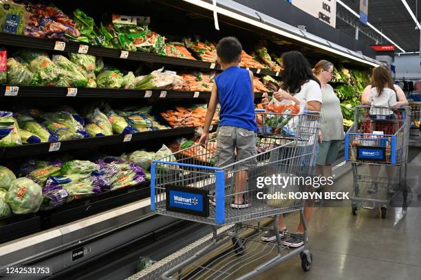 Consumers shop in the produce section of a Walmart store in Burbank, California on August 15, 2022. - Walmart, the largest retailer the United...