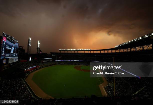 Rain storm is seen in the distance prior to a weather delay in the second inning between the Atlanta Braves and the New York Mets at Truist Park on...