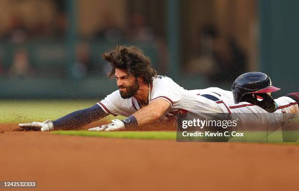 Dansby Swanson of the Atlanta Braves slides into second base on a double in the first inning against the New York Mets at Truist Park on August 15,...