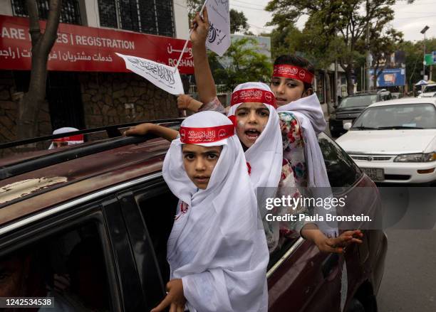 Afghan girls dress up to take part in a parade as Taliban celebrate the first anniversary of the Taliban takeover on August 15, 2022 in Kabul,...