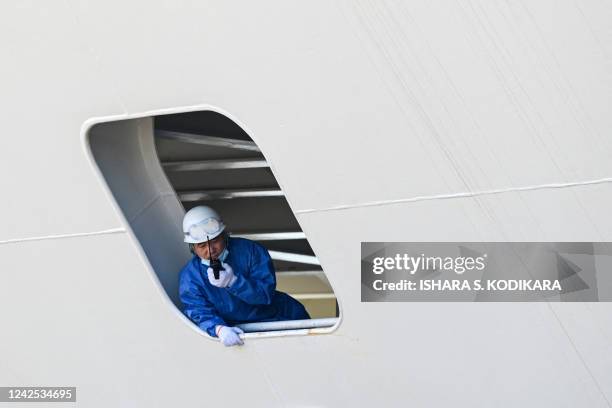 Crew member onboard China's research and survey vessel, the Yuan Wang 5, looks out from the ship upon arrival at Hambantota port on August 16, 2022....