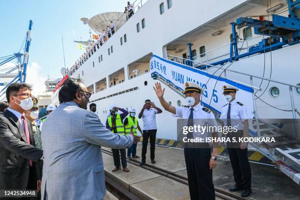 Captain Zhang Hogwang of China's research and survey vessel, the Yuan Wang 5, waves after disembarking from the ship upon arrival at Hambantota port...