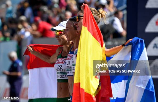 Third placed Hungary's Viktoria Madarasz, winner Greece's Antigoni Ntrismipioti and second placed Spain's Raquel Gonzalez celebrate after the women's...