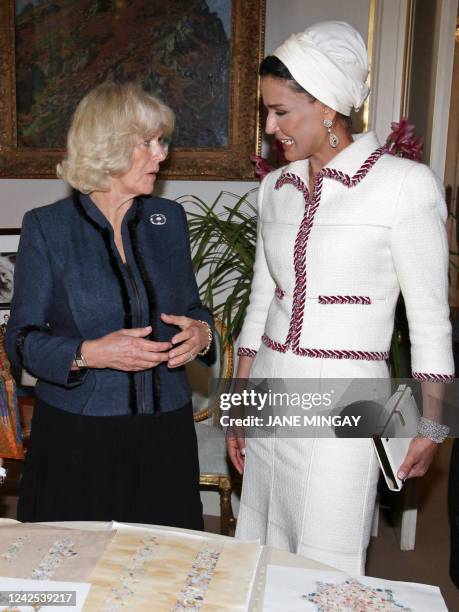 Britain's Camilla, the Duchess of Cornwall , gestures as she talks with Sheikha Mozah, the wife of Qatar's emir, Sheikh Hamad bin Khalifa al-Thani,...