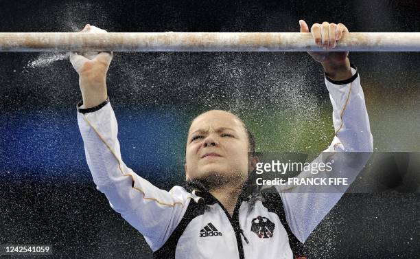 Joeline Moebius of Germany cleans the bars before performing during a practice session of the artistic gymnastics event of the Beijing 2008 Olympic...