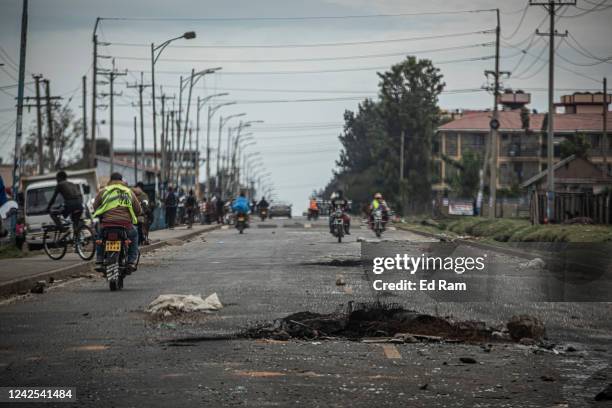 Debris from a protest the night before remains on a road after supporters of Azimio la Umoja presidential candidate Raila Odinga burned tyres and set...