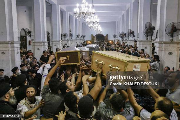 Egyptian mourners carry the coffin of Ibram Tamer Wageh a boy killed in a Cairo Coptic church fire, during a funeral at the church of the Blessed...