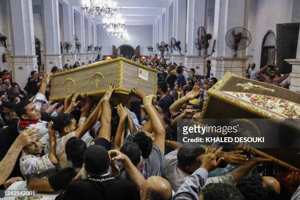 Egyptian mourners carry the coffin of Mariam Tamer Wageh , a girl killed in a Cairo Coptic church fire, during a funeral at the church of the Blessed...