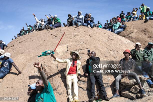 Mineworkers affiliated the Association of Mineworkers and Construction Union gather on the koppies in Marikana on August 16 during the 10th...