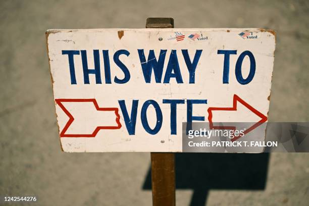 Sign reading "This Way To Vote" is displayed outside the Old Wilson Schoolhouse Community Center in Wilson, Wyoming, on August 16 as Wyoming holds...