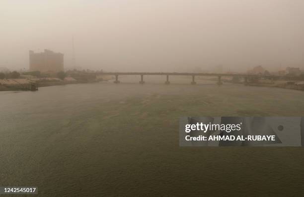 This picture taken on August 16, 2022 shows a view of a bridge over Tigris river in Iraq's capital Baghdad amidst a dust storm.