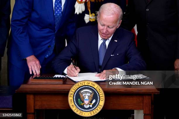 President Joe Biden signs H.R. 5376, the Inflation Reduction Act of 2022, in the State Dining Room of the White House in Washington, DC, on August...