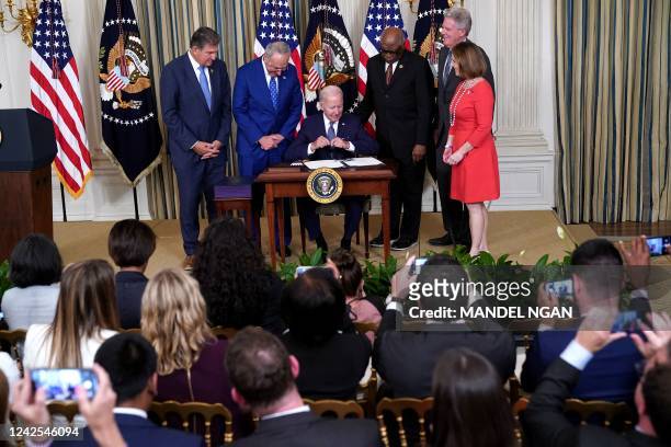 President Joe Biden signs H.R. 5376, the Inflation Reduction Act of 2022, in the State Dining Room of the White House in Washington, DC, on August...