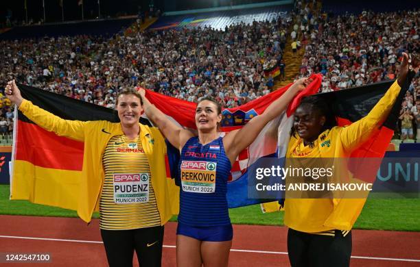 Croatia's Sandra Perkovic celbrates winning gold with silver medalist Germany's Kristin Pudenz and bronze medalist Germany's Claudine Vita after the...