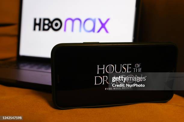 'House of the Dragon' series logo displayed on a phone screen and HBO Max logo displayed on a laptop screen are seen in this illustration photo taken...