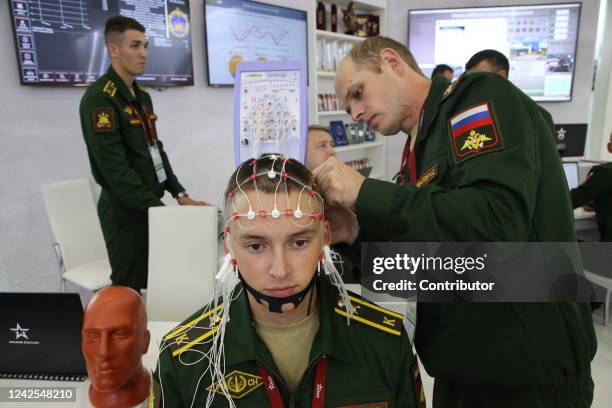 Russian officer prepares a brain test for a student of a military institute during the International Military Technical Forum 'Army 2022' at Alabino...