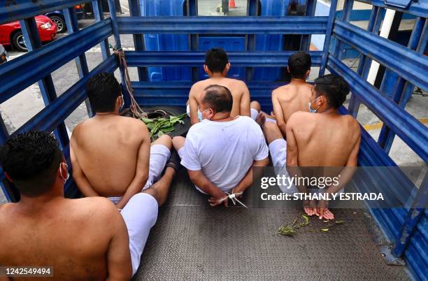 Suspects of belonging to a criminal band are taken away in a police truck during a security operation against gang violence in Soyapango, just east...