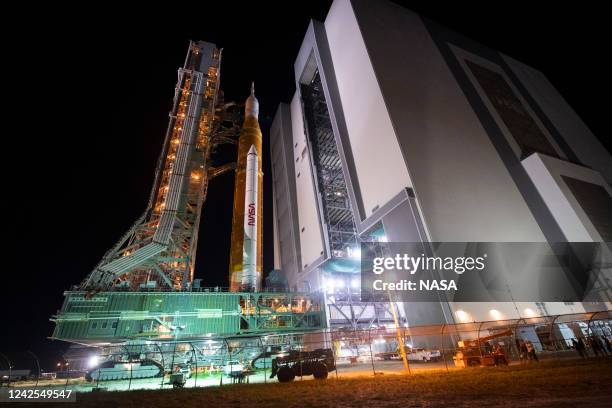 In this handout image provided by NASA, NASA's Space Launch System rocket with the Orion spacecraft aboard is seen atop a mobile launcher as it rolls...
