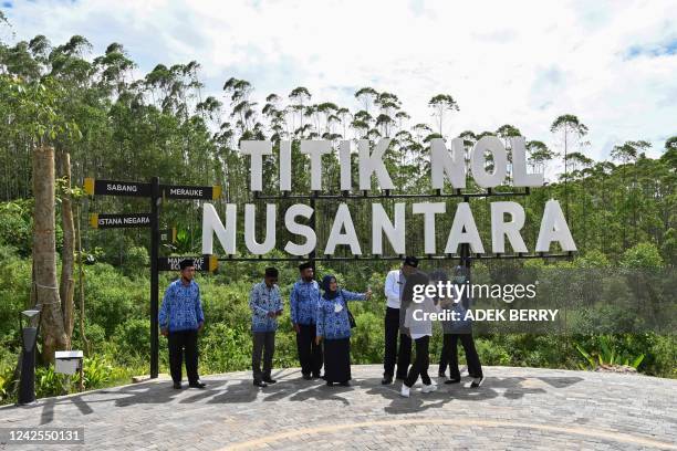 Attendees stand by a lookout point where a flag-raising ceremony was held at ground zero of Indonesia's future capital in Sepaku, Penajam Paser...