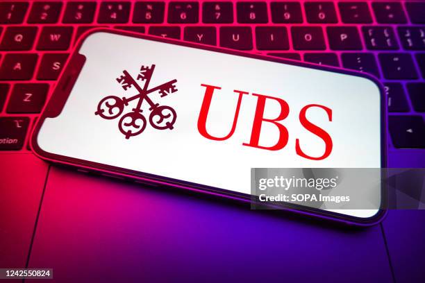 In this photo illustration, the UBS Group AG logo is displayed on a smartphone screen.