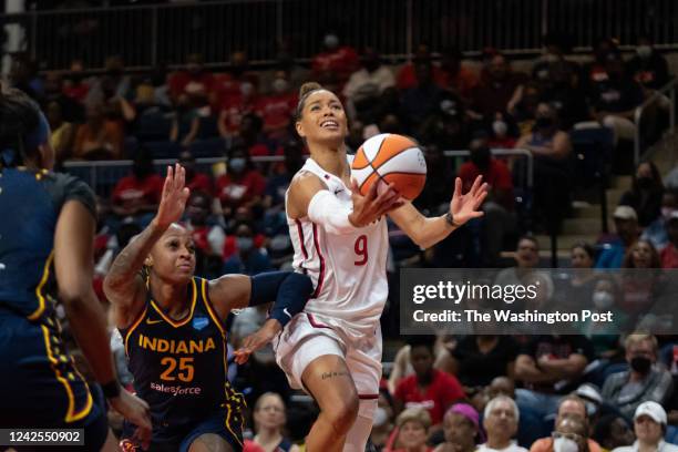 Washington Mystics guard Natasha Cloud attempts a shot as Indiana Fever guard Tiffany Mitchell defends during the game at the Entertainment and...