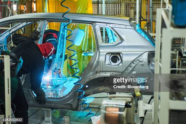 Workers weld an automobile chassis on the production line at the Toyota Motor Corp. Manufacturing plant in Durban, South Africa, on Tuesday, Aug. 16,...