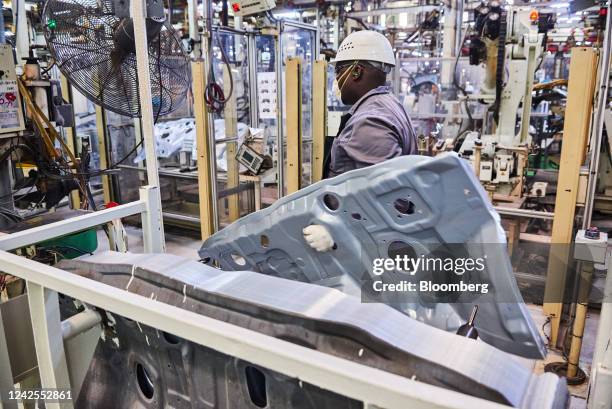 Worker moves a steel panel on the automobile production line at the Toyota Motor Corp. Manufacturing plant in Durban, South Africa, on Tuesday, Aug....