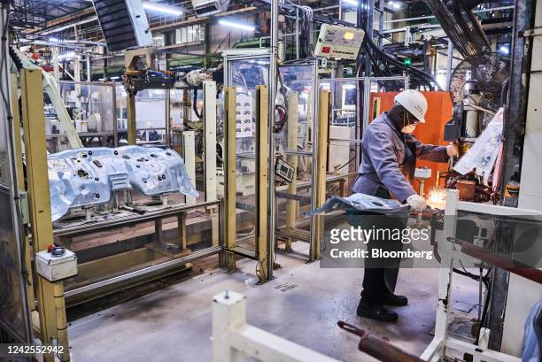 Worker prepares steel panel parts on the automobile production line at the Toyota Motor Corp. Manufacturing plant in Durban, South Africa, on...