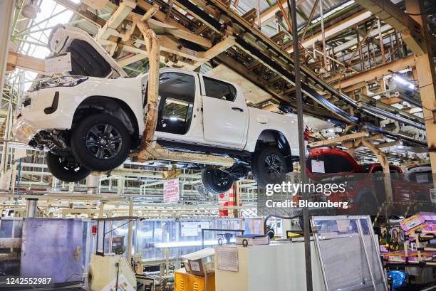 Overhead cradles move Hilux automobiles along the production line at the Toyota Motor Corp. Manufacturing plant in Durban, South Africa, on Tuesday,...