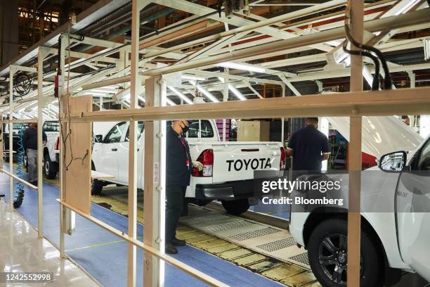 Workers inspect Hilux vehicles on the automobile production line at the Toyota Motor Corp. Manufacturing plant in Durban, South Africa, on Tuesday,...