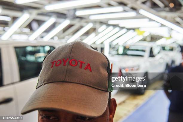 Worker wears a branded cap on the automobile production line at the Toyota Motor Corp. Manufacturing plant in Durban, South Africa, on Tuesday, Aug....