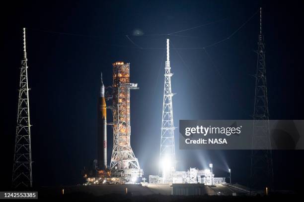 In this handout image provided by NASA, NASA's Space Launch System rocket with the Orion spacecraft aboard is seen atop a mobile launcher as it rolls...