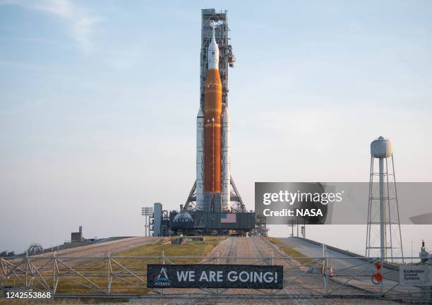 In this handout image provided by NASA, NASA's Space Launch System rocket with the Orion spacecraft aboard is seen atop the mobile launcher at Launch...