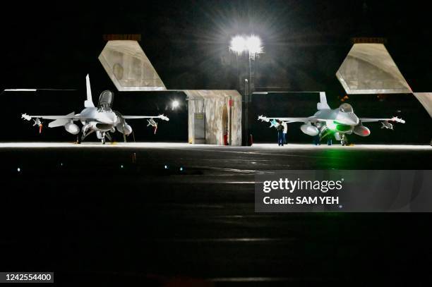 Air Force staffs inspect a F-16V fighter jet during a drill at Hualien Air Force base on August 17, 2022.